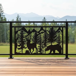 May include: A black metal railing panel featuring a laser-cut silhouette design of a forest landscape. The scene depicts a deer standing among pine trees with a bear walking nearby and a mountain range visible in the background of the cutout.