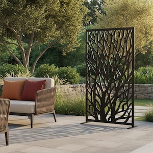 May include: A rectangular, dark brown metal privacy screen featuring an intricate, laser-cut pattern of organic, branching tree limbs. The freestanding panel is supported by two flat, horizontal metal feet at the base, providing stability.