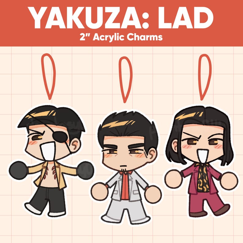 May include: Three 2-inch acrylic charms featuring characters from Yakuza: LAD. Each charm depicts a stylized character with distinct outfits and expressions. The top of the image reads "YAKUZA: LAD" in white text on a red background.
