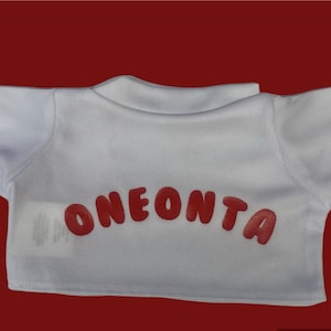May include: White t-shirt with short sleeves and the word "ONEONTA" printed in red bubble letters on the back.