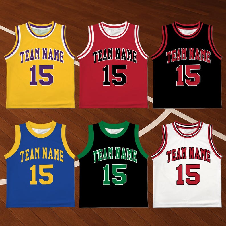 May include: Six basketball jerseys in various colors: yellow, red, black, blue, green, and white. Each jersey has the text "TEAM NAME" and the number "15" in contrasting colors. The jerseys are displayed on a wooden basketball court.