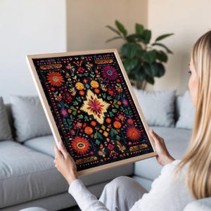 May include: A framed print of a colorful floral design on a black background. The design features a variety of flowers and leaves in shades of red, orange, yellow, green, and blue. The print is surrounded by a simple wooden frame.