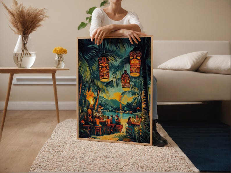May include: A framed print depicting a tropical scene with tiki torches, palm trees, and a bar with people. The artwork features vibrant colors, including greens, yellows, and blues, creating a lively atmosphere. The print is held by a person.