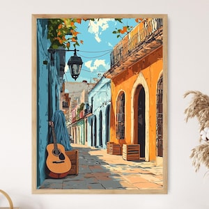 May include: A framed art print showing a vibrant street scene. The artwork features buildings in orange and blue, a guitar, and a lantern. The style is similar to a watercolour painting, creating a warm and inviting atmosphere.