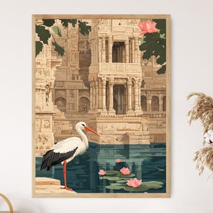 May include: A framed art print featuring a detailed illustration of an ancient Indian temple complex. A white stork with black wingtips and a red beak stands near a body of water with pink lotus flowers. The artwork has a vintage aesthetic.