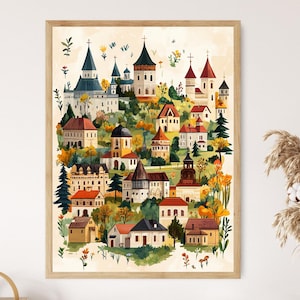 May include: A watercolour print depicting a European village scene, featuring churches and houses on a hillside. The artwork uses a warm colour palette of orange, yellow, and green, presented in a light wood frame.