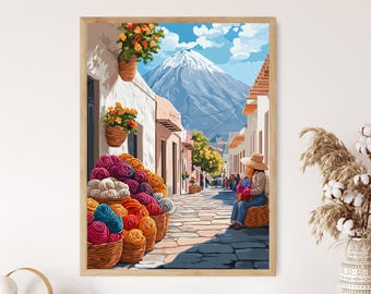 May include: A framed art print depicts a vibrant street scene in a South American town. Baskets overflowing with colorful yarn sit in the foreground. A person in a hat sits on a basket, and a snow-capped mountain is in the background.