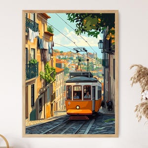 May include: Framed art print depicting an orange and white tram car on a cobbled street. The tram is on tracks, flanked by buildings. The background shows a cityscape and the sea. The artwork is in a wooden frame.