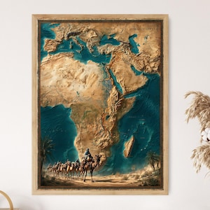 May include: Framed wall art featuring a detailed 3D relief map of Africa and surrounding regions. The map is rendered in shades of brown and teal, with a caravan of camels at the bottom. The artwork is encased in a wooden frame.
