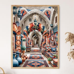 May include: A framed print of an arched marketplace with colorful rugs, textiles, and pottery. The scene features a long corridor with detailed architecture, lanterns, and a variety of goods on display, creating a vibrant and inviting atmosphere.