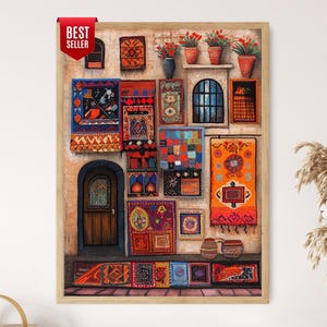 May include: A framed wall art print depicting a stone building facade adorned with numerous colorful, patterned textile rugs and tapestries. The scene includes a wooden arched door, potted red flowers, and a red banner labeled BEST SELLER.