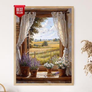 May include: A framed print depicting a window overlooking a rural landscape. The window has lace curtains, potted lavender and daisies, and a view of a field under a blue sky. The print includes a "BEST SELLER" tag.