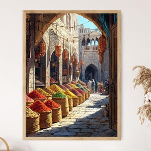 May include: A framed print of a vibrant Middle Eastern market scene. The artwork depicts a stone archway leading into a bustling marketplace, with colorful spices in woven baskets. Lanterns hang overhead, and people are seen in the distance.