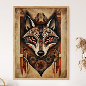 May include: A framed art print depicting a stylized wolf's face with detailed geometric patterns. The artwork uses a palette of browns, oranges, and blacks, with striking orange eyes. The design has an indigenous art style.