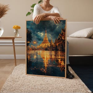 May include: A framed art print depicting a golden pagoda and buildings reflecting in the water. The artwork has a warm color palette with gold, orange, and blue hues. The image is set in a rainy environment with lights illuminating the scene.