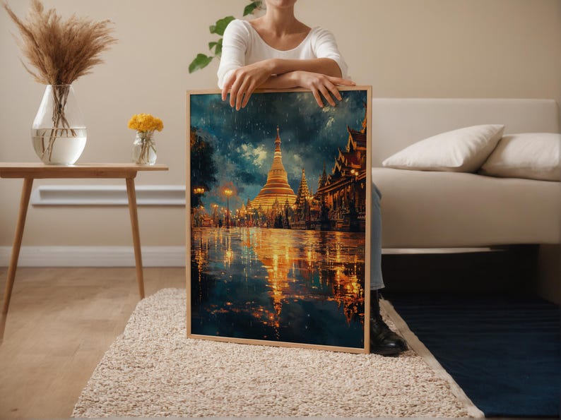 May include: A framed art print depicting a golden pagoda and buildings reflecting in the water. The artwork has a warm color palette with gold, orange, and blue hues. The image is set in a rainy environment with lights illuminating the scene.