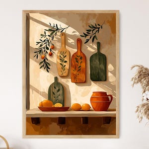 May include: A framed print depicting a still life arrangement. It features wooden chopping boards with leaf patterns, oranges, and a terracotta jug. The colour scheme includes warm browns, oranges, and greens, creating a rustic aesthetic.