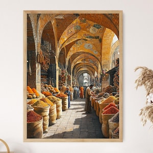 May include: A framed print of a bustling spice market. The image showcases a long, arched corridor filled with sacks of colorful spices. People in traditional clothing are seen browsing the market. The architecture features warm, earthy tones.