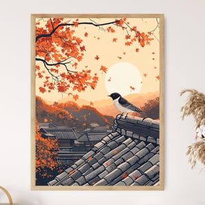 May include: A framed art print showing a Japanese landscape with a bird on a tiled roof. The artwork features an autumn scene with orange foliage, a full moon, and mountains. The bird has black and white feathers. The print is in a wooden frame.
