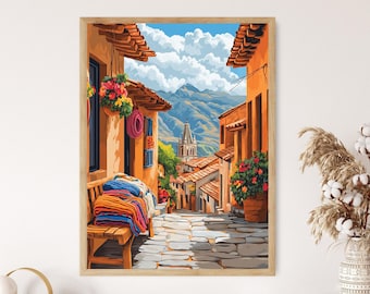 May include: A framed print of a colorful street scene in a mountain town. The artwork depicts buildings with orange walls, red tile roofs, and a cobblestone street. A wooden bench holds folded blankets. Flowers and a church steeple are visible.