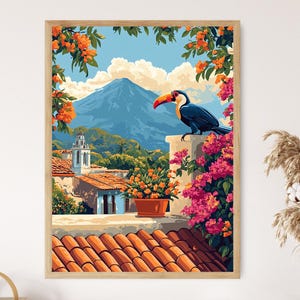 May include: A framed art print showcasing a colourful tropical landscape. A toucan with an orange beak is perched on a wall, overlooking a village with red-tiled roofs and a mountain backdrop. The artwork features bright colours and lush floral elements.
