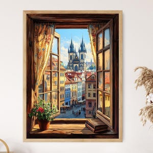 Könnte beinhalten: Ein Gemälde, das ein Fenster mit Blick auf eine Stadtlandschaft zeigt. Das Fenster ist geöffnet und die Vorhänge sind zurückgezogen. Die Stadtlandschaft im Hintergrund umfasst eine Kirche mit zwei Türmen. Das Gemälde befindet sich in einem Holzrahmen.