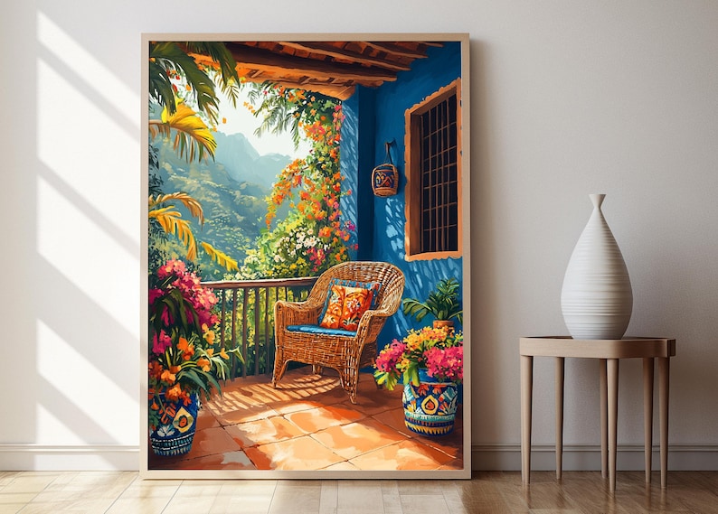 May include: A framed watercolor painting depicts a vibrant outdoor scene. A wicker chair with a blue cushion and patterned pillow sits on a tiled patio. Lush plants and flowers in decorative pots surround the patio, with a mountain view in the background.