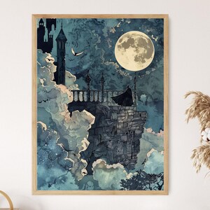 May include: A framed art print featuring a gothic scene with a full moon in a cloudy, teal sky. A figure in a black cloak stands on a stone balcony overlooking a landscape with a castle and flying birds. The artwork has a vintage, watercolor style.
