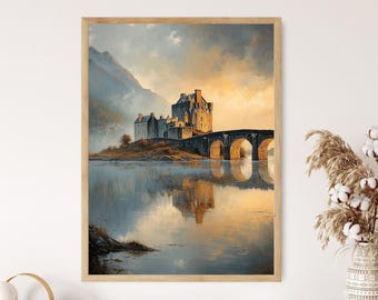 May include: A framed print of a castle on a small island, connected by a stone bridge. The artwork features a muted color palette with a reflection of the castle in the water. The sky is a blend of orange and blue, and the frame is a light wood.