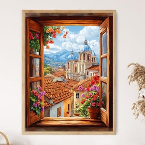 May include: A framed painting depicts a vibrant cityscape viewed through an open wooden window. The artwork showcases buildings with red-tiled roofs, a church with blue domes, and colorful flowers. The scene is set against a backdrop of mountains and a bright blue sky.