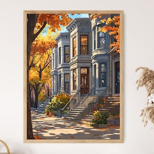Puede incluir: Una impresión artística enmarcada de una hilera de casas adosadas en otoño. Los edificios están pintados en tonos grises y beige, con puertas marrones y barandillas negras. La escena está enmarcada por árboles con hojas naranjas y amarillas, y la acera está cubierta de hojas caídas.