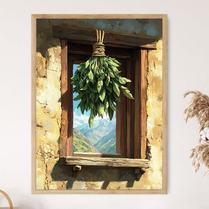 May include: A framed print depicts a rustic window with a bundle of green herbs hanging inside. The window, framed in weathered wood, offers a view of a mountain range. The stone wall around the window is a warm, earthy tone.