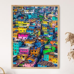 May include: A vibrant aerial view of a densely packed neighborhood with colorful houses. The houses are painted in a variety of bright colors, including yellow, blue, green, pink, and red. The houses are clustered together, creating a sense of community and vibrancy.