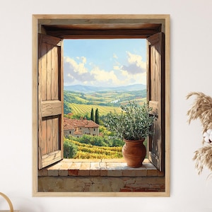 Op de afbeelding: Een ingelijst schilderij van een Toscaans landschap, gezien door een open raam met houten luiken. De scène toont glooiende heuvels, wijngaarden, een boerderij en een terracotta pot met groen op de vensterbank. De lucht is blauw met witte wolken.