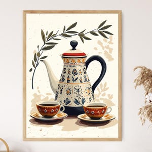 May include: A white ceramic teapot with blue and yellow floral designs, a black handle, and a red lid. Two small red and brown teacups with saucers are placed on a white surface with a green olive branch in the background.