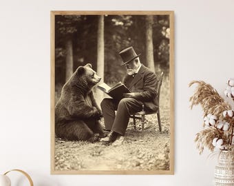 May include: A vintage black and white photograph of a man in a top hat sitting with a bear. The man is reading a book to the bear. The photo is framed in a wooden frame.