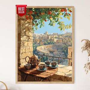 May include: A framed wall art print featuring a balcony scene with a wooden table, a metallic teapot, and three teacups. The view overlooks an ancient stone amphitheater and city buildings under a clear sky, with orange fruit tree branches above.