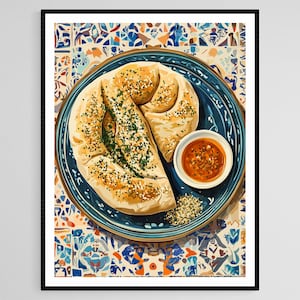 May include: A framed print of a watercolor painting depicting a plate of bread with a small bowl of sauce. The bread is light brown and sprinkled with herbs and seeds. The plate is blue with a decorative rim, and the background is a colorful tile pattern.