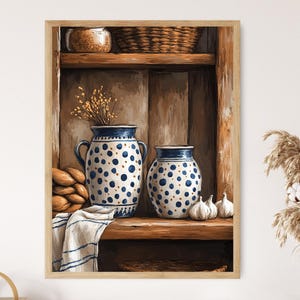 May include: A framed print of a rustic kitchen scene. Two blue and white polka-dot ceramic vases sit on a wooden shelf, alongside garlic bulbs and a folded towel. A basket and a jar are on the top shelf.