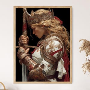 May include: A framed print of a medieval warrior, wearing ornate gold armor and a crown, holding a sword. The warrior has long blonde hair and a red cape. The artwork has a dark background and is displayed in a wooden frame.