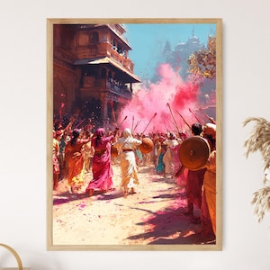 May include: A framed art print depicting a vibrant Holi festival scene. People in colorful clothing are throwing pink powder, creating a cloud of color. The artwork captures the festive atmosphere with a focus on movement and celebration.