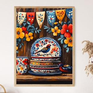 May include: A framed print featuring a still life of colorful ceramic plates and a cup, adorned with floral and bird motifs. The plates are stacked, and a small bird figurine sits nearby. The background includes decorative banners and flowers, all set against a wooden backdrop.