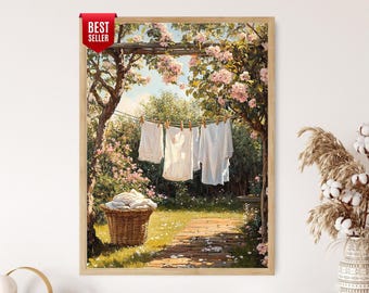 May include: A framed print of a vintage laundry scene. White shirts hang on a clothesline in a garden with a stone path. A wicker basket holds folded laundry. The artwork is surrounded by lush greenery and pink flowers.