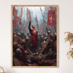 May include: A framed print depicting a medieval battle scene. A central figure in red armor raises a sword amidst a crowd of soldiers and fallen comrades. Red flags with crosses wave in the background, creating a dramatic and historical artwork.
