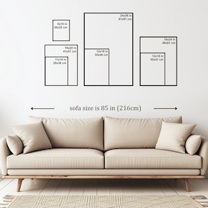 May include: A diagram showing different sizes of framed artwork above a beige sofa. The sofa is 85 inches (216 cm) wide. The artwork sizes are listed in inches and centimeters.