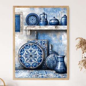 May include: A framed print featuring blue and white ceramic pottery. The artwork depicts plates, vases, and a pitcher with intricate patterns, arranged on a shelf and a tiled surface. The color palette is dominated by shades of blue and white.