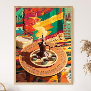 May include: A framed print depicts a Middle Eastern coffee setting. A brown coffee pot sits on a round table with three small cups. A woven basket and colorful rug are in the background. The artwork is framed in a light wood.