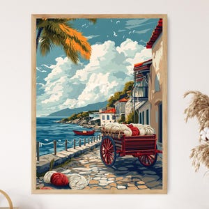 Könnte beinhalten: Ein gerahmter Kunstdruck zeigt eine Küstenlandschaft mit einem roten Wagen voller Garn. Das Kunstwerk zeigt ein blaues Meer, weiße Wolken und Gebäude mit roten Dächern. Eine Palme und ein kleines rotes Boot sind ebenfalls zu sehen.