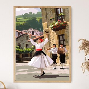 May include: A framed print shows a traditional Basque dance scene. A woman in a white dress, red sash, and black apron dances with a hat raised. Two musicians play instruments. The background shows a European village.