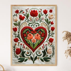May include: Framed artwork featuring a heart-shaped floral design. The heart is filled with red and orange flowers, surrounded by green leaves and red tulips. The artwork is framed in a light wood frame, creating a decorative piece.